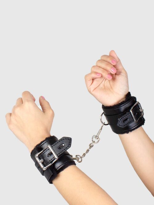 La marque Secret Play propose cette paire de menottes de bondage Vegan, en cuir synthétique, peluche et métal, réglables pour être utilisées indifféremment comme menottes de poignets ou de chevilles.